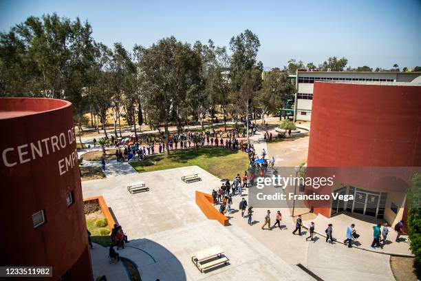 Citizens line up outside a vaccination center to receive the U.S. Donated Johnson & Johnson vaccine against Covid-19 at Universidad de Baja...
