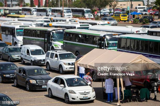 Citizens in cars attend the drive-in vaccination center to receive the U.S. Donated Johnson & Johnson vaccine against Covid-19 at Universidad de Baja...