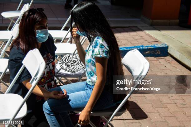 Person sits while crying before receiving the U.S. Donated Johnson & Johnson vaccine against Covid-19 at Universidad de Baja California on June 17,...