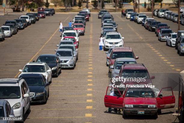 Citizens in cars attend the drive-in vaccination center to receive the U.S. Donated Johnson & Johnson vaccine against Covid-19 at Universidad de Baja...