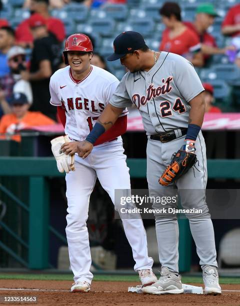 Miguel Cabrera of the Detroit Tigers jokes around with starting pitcher Shohei Ohtani of the Los Angeles Angels during the first inning after Ohtani...