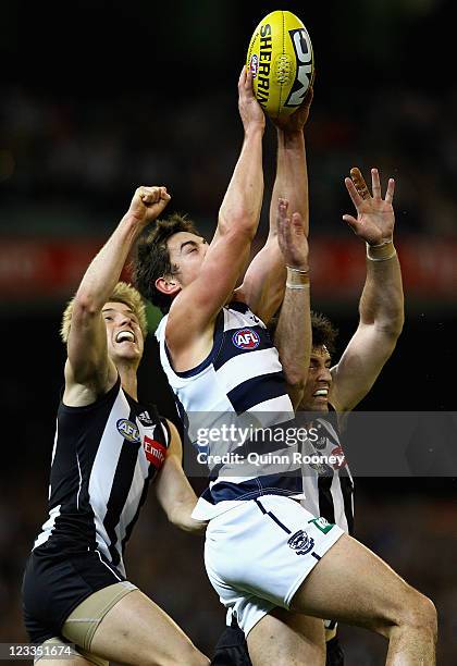 Daniel Menzel of the Cats marks infront of Leigh Brown of the Magpies during the round 24 AFL match between the Collingwood Magpies and the Geelong...