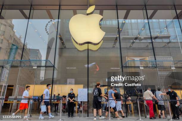 Customers enter an Apple Store on Nanjing Road Pedestrian Street in Shanghai, China, June 18, 2021.