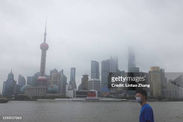 Tourist wearing protective mask visits the Bund waterfront area as China celebrates the 100th anniversary of the founding of the Communist Party of...