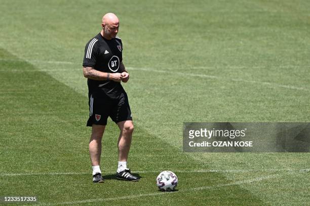 Wales' coach Robert Page walks on the pitch during a training session at Tofiq Behramov Stadium in Baku on June 18, 2021 as part of the UEFA EURO...
