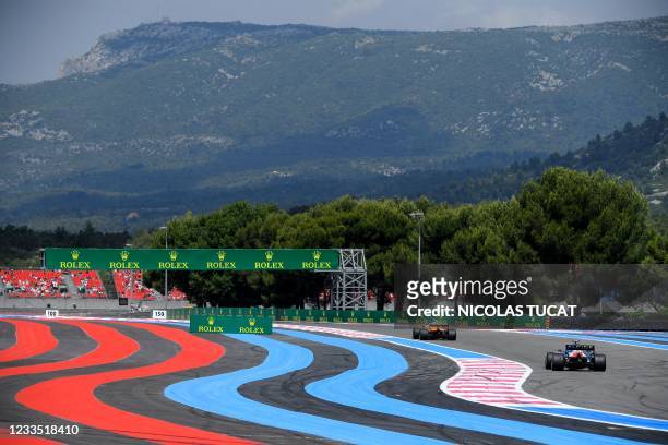McLaren's British driver Lando Norris drives ahead of Alpine's French driver Esteban Ocon during the first practice session at the Circuit...