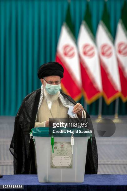 Iran's Supreme Leader Ayatollah Ali Khamenei wears a face mask as he casts his ballot on June 18 on the day of the Islamic republic's presidential...
