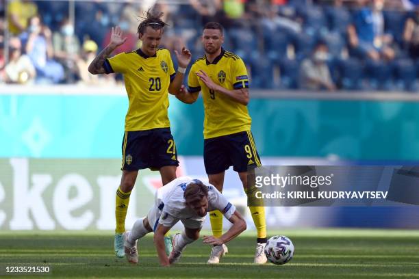 Slovakia's midfielder Juraj Kucka falls in front of Sweden's midfielder Kristoffer Olsson and Sweden's forward Marcus Berg during the UEFA EURO 2020...
