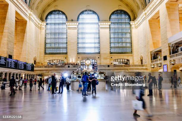 Pedestrians wearing protective masks walk through Grand Central in New York, U.S., on Monday, June 14, 2021. On Tuesday, Governor Andrew Cuomo lifted...