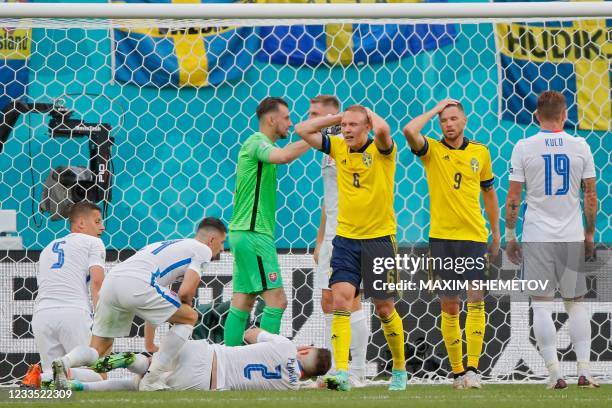 Sweden's defender Ludwig Augustinsson and Sweden's forward Marcus Berg react after missing a goal opportunity during the UEFA EURO 2020 Group E...