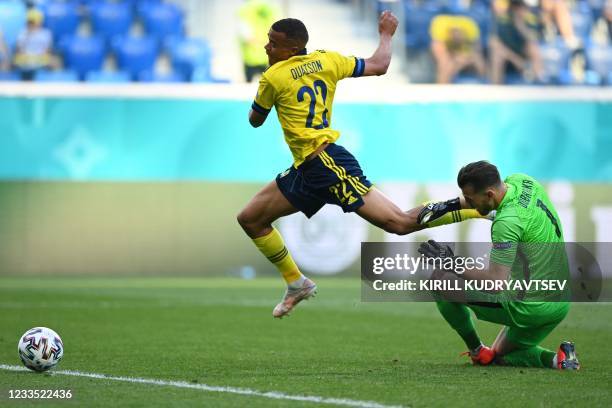 Sweden's midfielder Robin Quaison is fouled by Slovakia's goalkeeper Martin Dubravka during the UEFA EURO 2020 Group E football match between Sweden...