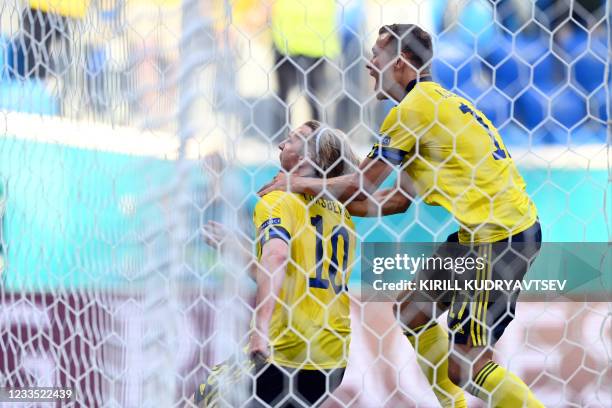 Sweden's midfielder Emil Forsberg celebrates with Sweden's midfielder Viktor Claesson after scoring a goal during the UEFA EURO 2020 Group E football...