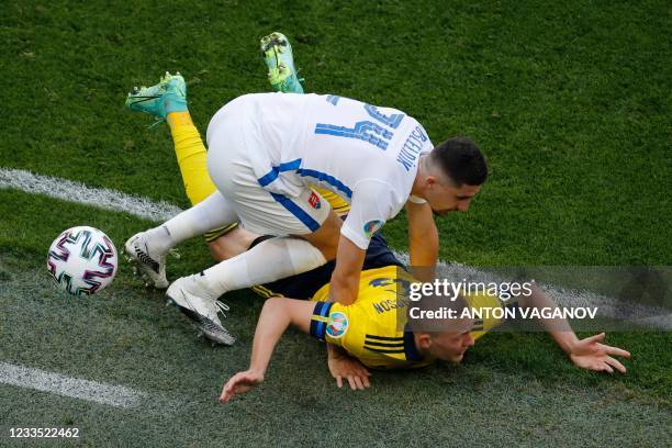 Slovakia's defender Martin Koscelnik falls over Sweden's defender Ludwig Augustinsson during the UEFA EURO 2020 Group E football match between Sweden...