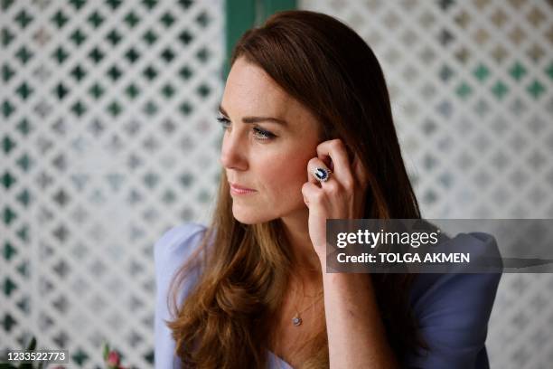 Britain's Catherine, Duchess of Cambridge looks on as she meets with a group of parents who have helped her understand the importance of providing...