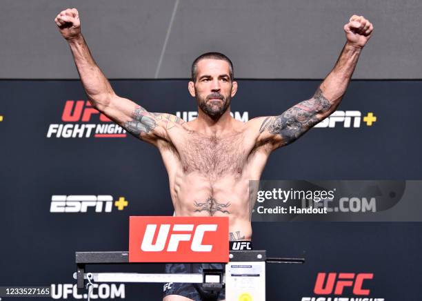 In this UFC handout, Matt Brown poses on the scale during the UFC weigh-in at UFC APEX on June 18, 2021 in Las Vegas, Nevada.