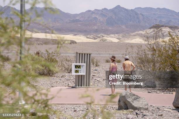 Visitors view the thermometer at the Furnace Creek Visitor Center in Death Valley, California, U.S., on Thursday, June 17, 2021. The searing weather...