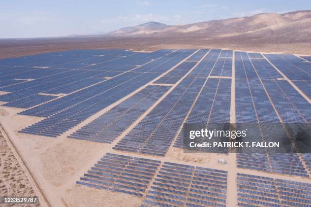 An aerial image shows solar panels part of an electricity generation plant on June 18, 2021 in Kern County near Mojave, California. - The California...