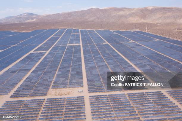 An aerial image shows solar panels part of an electricity generation plant on June 18, 2021 in Kern County near Mojave, California. - The California...