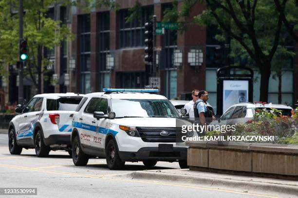 Chicago Police officers monitor Michigan Avenue in Chicago, Illinois, on June 18, 2021. - Businesses and restaurants in downtown Chicago that...