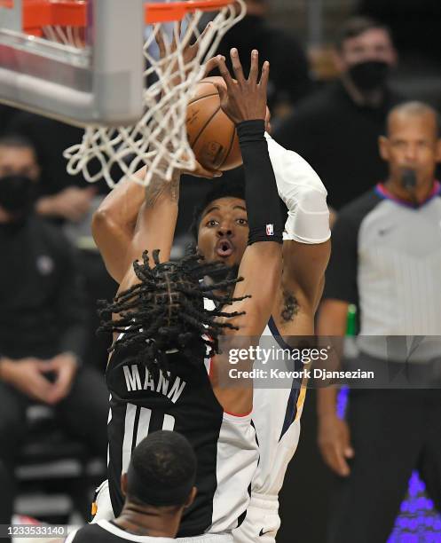 Donovan Mitchell of the Utah Jazz shoots over Terance Mann of the Los Angeles Clippers during the first half in Game Six of the Western Conference...