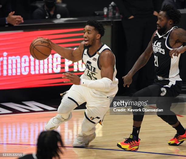 Donovan Mitchell of the Utah Jazz drives against Patrick Beverley of the Los Angeles Clippers during the first half in Game Six of the Western...