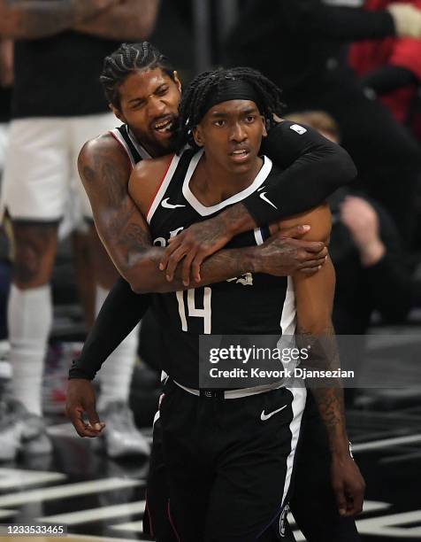 Paul George of the Los Angeles Clippers hugs as they celebrate a slam dunk by Terance Mann of the Los Angeles Clippers against Utah Jazz during the...