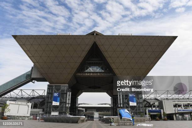 Workers install a banner at Tokyo Big Sight, the press center and international broadcasting center during the Tokyo 2020 Olympic and Paralympic...