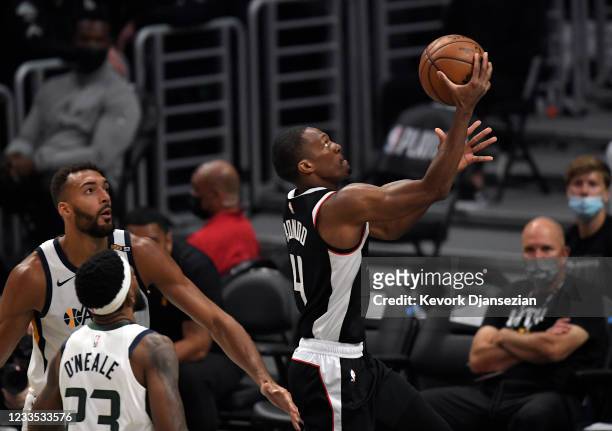 Rajon Rondo of the Los Angeles Clippers scores a basket against Rudy Gobert of the Utah Jazz during the first half in Game Six of the Western...