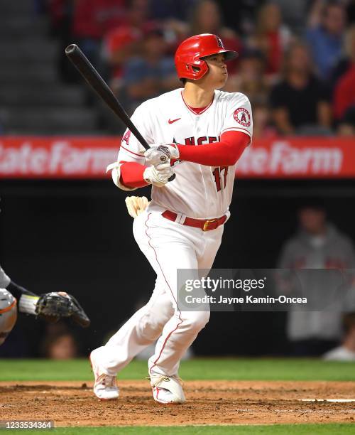 Shohei Ohtani of the Los Angeles Angels watches the ball clear the wall on a two run home run in the fifth inning of the game against the Detroit...