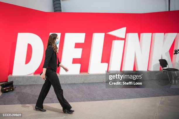 Janine Wissler, lead candidate of the left-wing Die Linke political party, walks in front of the party logo at the party's federal congress on June...