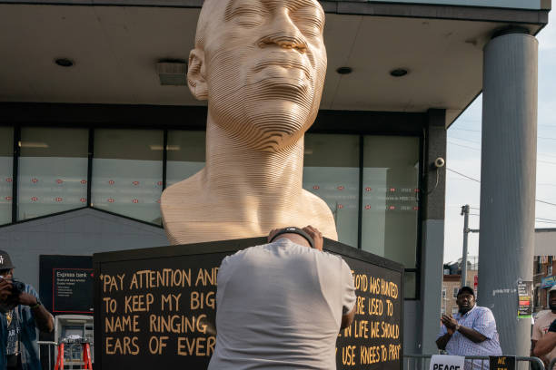 Terrance Floyd weeps during the unveiling of a statute dedicated to his brother George Floyd at Flatbush Junction on June 19 in the Brooklyn borough...