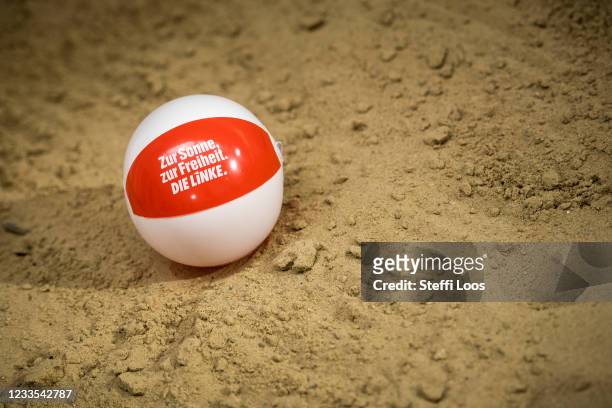 An inflatable ball with the imprint "To the sun, to the freedom. The Left." lies in the sand at the left-wing Die Linke political party federal...