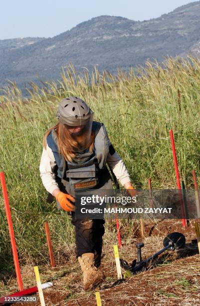 Lebanese deminer Hala Naameh works with her team of the Mines Advisory Group international NGO at a field slated for demining in the southern...