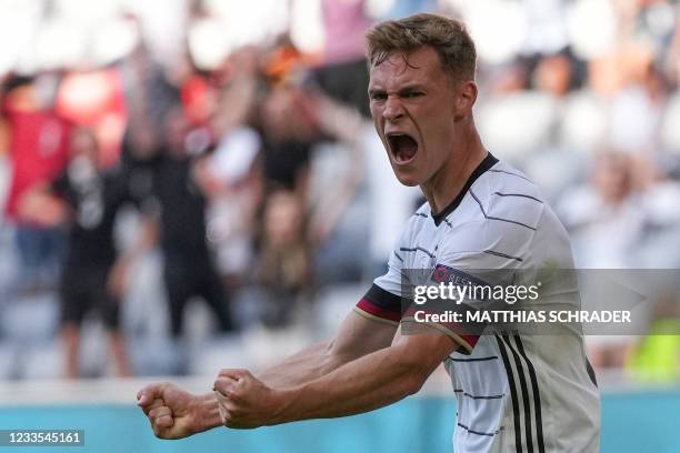 Germany's midfielder Joshua Kimmich celebrates their second goal, an own goal scored by Portugal's defender Raphael Guerreiro, during the UEFA EURO...