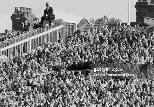 Policeman keeping an eye on the Chelsea supporters as they cheer on their team during the Canon League Division One match between Luton Town and...