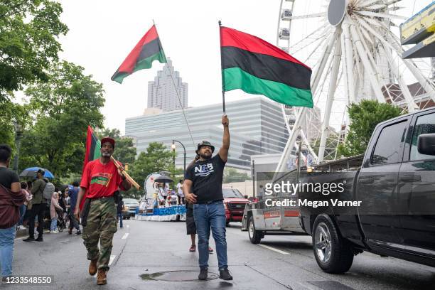 People participate in a parade to celebrate Juneteenth on June 19, 2021 in Atlanta, Georgia. Juneteenth marks the end of slavery in the United States...