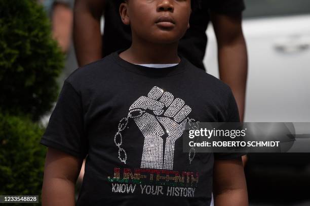 Boy listens to Live Go-Go music playing at Black Lives Matter Plaza in Washington, DC, on June 19 during a Juneteenth celebration. - The US on June...