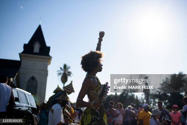 Prescylia Mae raises her fist in the air during a Juneteenth re-enactment celebration in Galveston, Texas, on June 19, 2021. - The US on June 17...