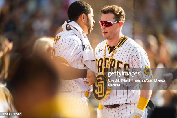 Jake Cronenworth of the San Diego Padres celebrates with the 'swag chain' after a home run in the third inning against the Cincinnati Reds on June...