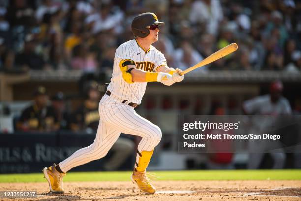 Jake Cronenworth of the San Diego Padres hits a home run in the third inning against the Cincinnati Reds on June 19, 2021 at Petco Park in San Diego,...