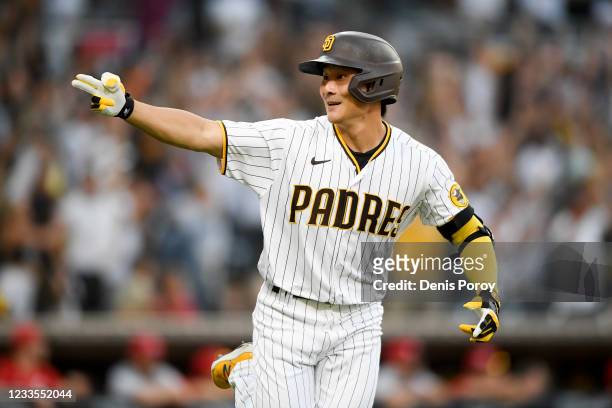Ha-Seong Kim of the San Diego Padres reacts towards the dugout after hitting a two-run home run during the eighth inning of a baseball game against...
