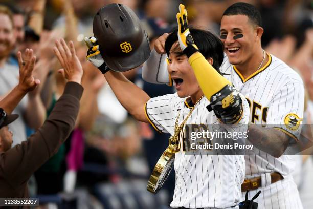 Ha-Seong Kim of the San Diego Padres is congratulated after hitting a two-run home run during the eighth inning of a baseball game against the...