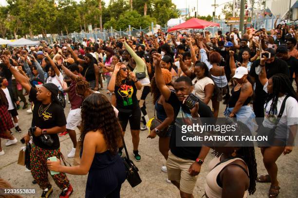 People dance during the Leimert Park Rising Juneteenth celebration on June 19, 2021 in the Leimert Park neighborhood of Los Angeles, California. -...