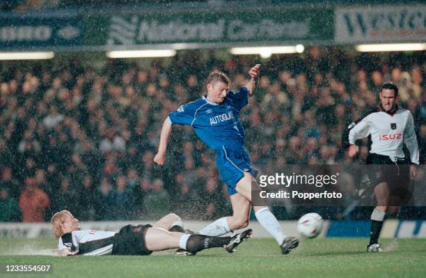 Tore Andre Flo of Chelsea shoots towards goal despite a sliding tackle from Colin Hendry of Coventry City during an FA Carling Premiership match in...