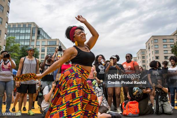 Woman dances to live music as she celebrates Juneteenth at Black Lives Matter Plaza near the White House in Washington, DC. Juneteenth marks the end...