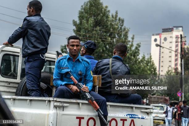 Police officers are seen waiting to escort ballot boxes on a car from a distribution center in Addis Ababa, Ethiopia, on June 20, 2021 to be...