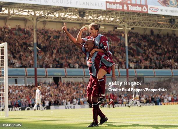 Dion Dublin of Aston Villa celebrates after scoring with teammate Lee Hendrie on his shoulders during the FA Carling Premiership match between Aston...