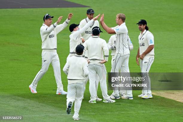 New Zealand's Kyle Jamieson celebrates with teammates after taking the wicket of India's Virat Kohli for 44 runs on the third day of the ICC World...