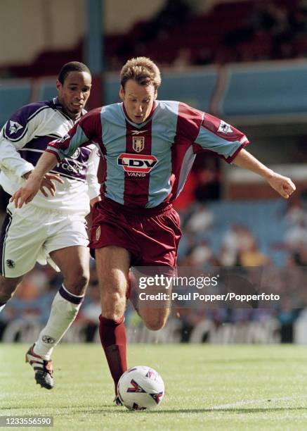 Paul Merson of Aston Villa is chased by Paul Ince of Middlesbrough during an FA Carling Premiership match at Villa Park on August 28, 1999 in...