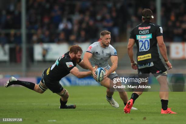 Jannes Kirsten and Don Armand of Exeter Chiefs in action with Byron McGuigan of Sale Sharks during the Gallagher Premiership Rugby Semi Final between...